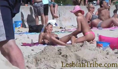 Young lesbians love public kissing and massage on the beach