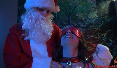 The Mommy Christmas Claus has fun with her slave