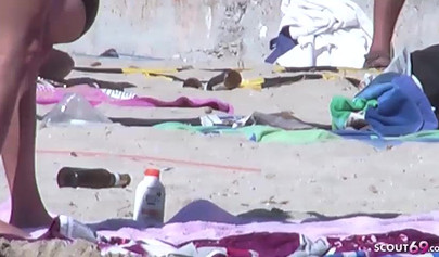 Lesbian couple spends time together on a nude beach