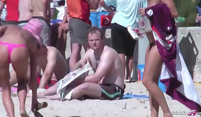 Lesbian couple spends time together on a nude beach