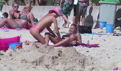 Lesbian couple spends time together on a nude beach