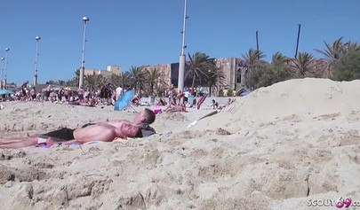 Lesbian couple spends time together on a nude beach