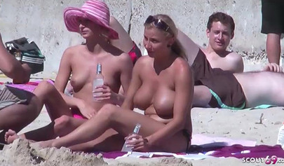 Lesbian couple spends time together on a nude beach