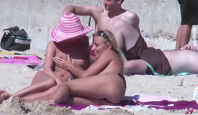 Lesbian couple spends time together on a nude beach