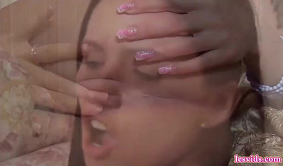 Dark-haired babes lick and toy each other's pussies