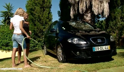 Beautiful blondes wash the car and lick pussies on the lawn
