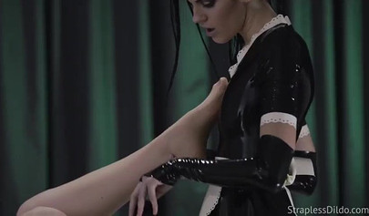 Latex-clad stunner fucks her submissive gf with a strapon