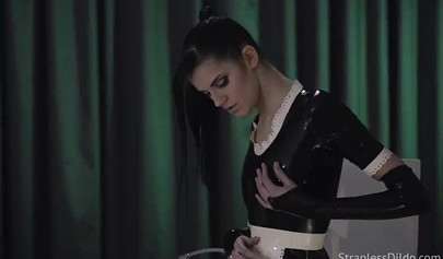 Latex-clad stunner fucks her submissive gf with a strapon