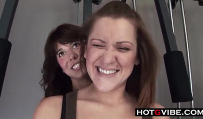 Lesbian couple enjoys strapon sex at the gym