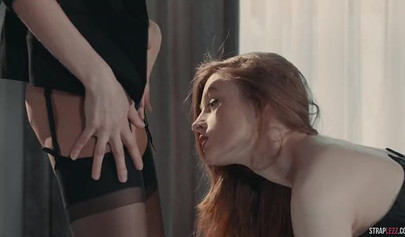 Two hot redhead lesbians are enjoying a strapon fuck