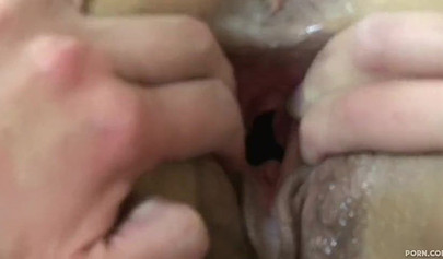 Blonde and brunette practice a vaginal fisting in bed