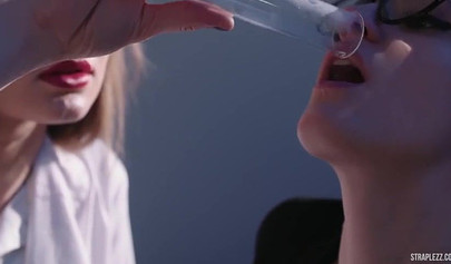 Bespectacled MILF fuckes a nurse with a strap-on