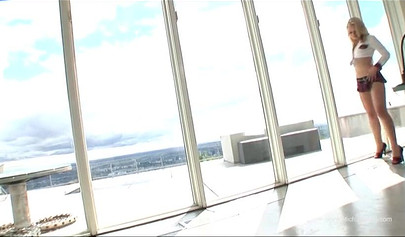 Glamorous lesbians playing with a glass dildo in a threesome