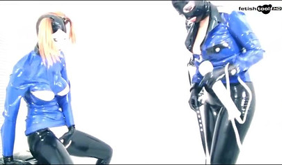 Voluptuous girls playing with a vibrator in a latex outfit