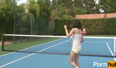 Redhead babe has lesbian sex with a brunette on a tennis court