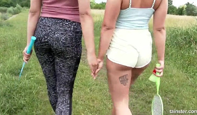 Amateur lesbians play tennis and pee on each other in the field