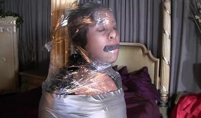 Two mature ladies enjoy a mummification fetish in the bedroom