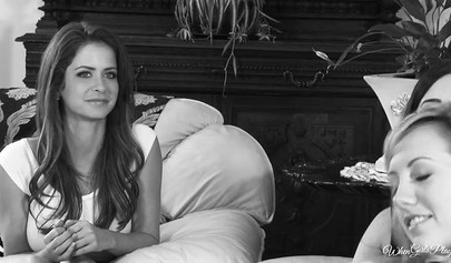 Redhead girl is satisfying a busty brunette in the bedroom