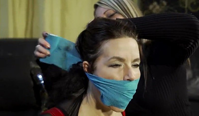 A busty tied up brunette was spanked by a blonde