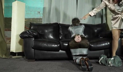 Domineering mistress practices bondage with a prisoner