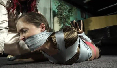 Domineering mistress practices bondage with a prisoner