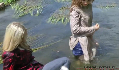 Attractive girls are swimming in clothes in the river